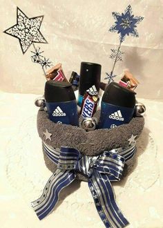 a basket filled with different items on top of a white tablecloth covered floor next to a christmas tree