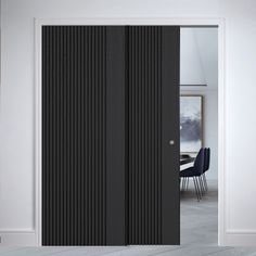 an open door with black vertical blinds on the outside, and a dining room table in the background