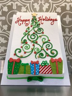 a decorated christmas tree cake sitting on top of a table