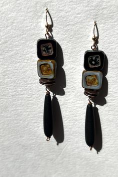 EARRINGS:  Black and grey sophistication in square Czech Picasso  high quality beads known for their vibrant colors!  Even this grey commands respect!  Black matte teardrop beads in a saturated endless black.  Earring wires are 14k gold filled (filled is 100 times thicker than plated!). Black Rectangular Beaded Jewelry, Handmade Black Contemporary Earrings, Contemporary Handmade Black Earrings, Grey Earrings, Black Earring, Gray Earrings, Earring Wires, Teardrop Beads, Earrings 3