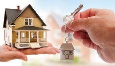 a hand holding a house key with the words easy home loan on it and an image of a person holding a house