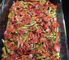 a casserole dish with green beans, tomatoes and other toppings on it