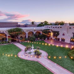 an aerial view of a courtyard with lights strung across the walkway, and landscaping around it