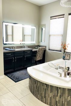 a large bathroom with two sinks and a bathtub in the middle of the room