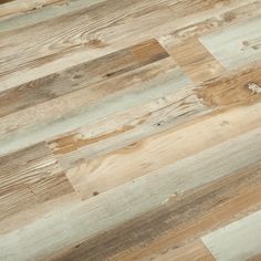 wood flooring that has been made from different types of boards and is very light brown