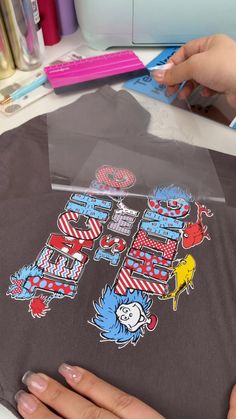 a person is making a t - shirt with the dr seuss thing on it