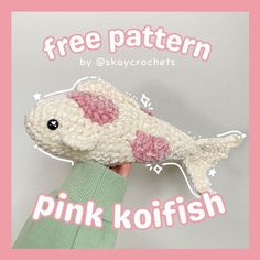 a hand holding a pink koi fish with the words free pattern by okaycrochets