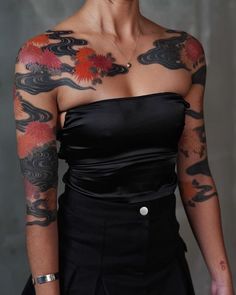 a woman with tattoos on her arm and shoulder