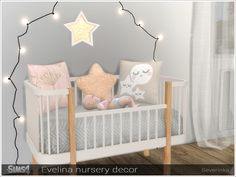 there is a baby crib with pillows on it and lights strung above the crib