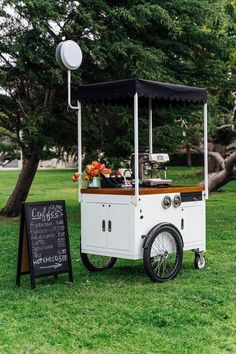 an ice cream cart is set up in the grass