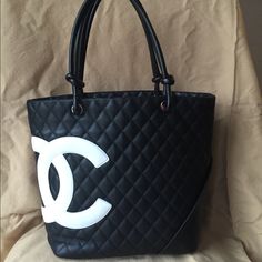 Reposhing This Item I Purchased From @Shakingfist. Authentic Black Chanel Cambon Tote With White Logo. Previously Authenticated By Poshmark When I Purchased And Will Be Again When You Purchase. I Will Include The Original Poshmark Authentication Card. Loved It, But It’s Been Sitting In My Closet Unused For 2 Years. Will Accept A Reasonable Offer. Please See Photos For Markings On Bottom Of Bag And Fading On White Logo. Both Are Easy Fixes; I Just Don’t Have The Time. Chanel Tote Bag Black, Chanel Cambon, Chanel Tote Bag, Chanel #1, Chanel Jumbo, Chanel Tote, Chanel Purse, Nylon Tote Bags, Pink Chanel