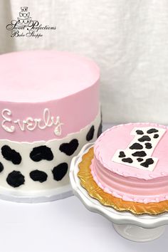 two cakes decorated with pink frosting and black polka dots are sitting on a table