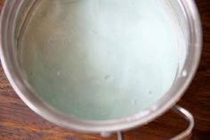 a blender filled with blue liquid on top of a wooden table