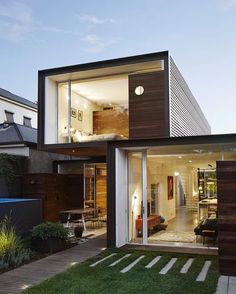 a modern house with an open floor plan and large sliding glass doors that lead to the backyard