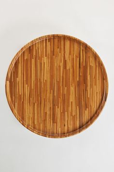 an oval wooden cutting board on a white background