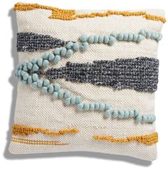 an embroidered pillow with beads on it