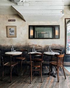 an empty restaurant with wooden tables and chairs