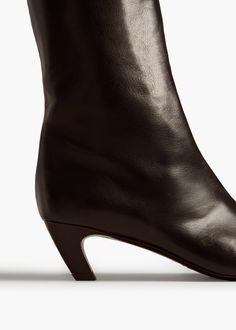 Made in Italy of smooth calfskin, this streamlined, square-toed style is free of closures for pull-on ease. Includes dust bag. Sleek Calf Leather Boots With Leather Lining, Sleek Calf Leather Boots With Square Toe, Sleek Square Toe Calf Leather Boots, Sleek Leather Boots With Sculpted Heel, Sleek Business Heeled Boots With Leather Lining, Sleek Brown Leather Boots, Sleek Business Heeled Boots With Square Toe, Sleek Square Toe Heeled Boots For Business, Classic Leather Heeled Boots With Contrasting Heel Counter