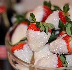 some strawberries are sitting in a glass bowl