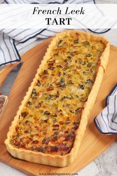 leek tart with onion and gruyre on a cutting board next to a knife