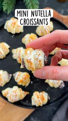 mini nutella croissants on a black plate with pine branches in the background