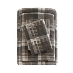 three pieces of plaid bedding set on a white background with black and grey colors