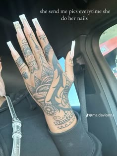 a woman's hand with tattoos on it and the words she send me pieces every time she do her nails