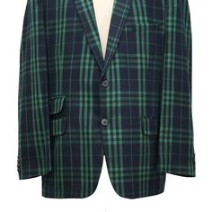 This Chiragh Apparel blazer is an elegant upgrade on dapper tailoring and features rich shades in a sumptuous fabric for elegant opulence. Fashioned from premium quality wool, this plaid check blazer features full lining in Japanese silk, a notch lapel, two-button closure and single-vented back. A left chest pocket and three flap pockets appoint the front while the inside has two (2) pockets on the left and one (1) pocket on the right. A flash of contrast piping is added to the jacket lining ins Fitted Green Sport Coat For Semi-formal Occasions, Elegant Green Blazer With Welt Pockets, Formal Tailored Green Tweed Jacket, Formal Green Outerwear With Suit Collar, Green Formal Outerwear With Suit Collar, Tailored Long Sleeve Sport Coat For Semi-formal Occasions, Elegant Green Blazer For Business, Elegant Green Business Blazer, Green Tweed Jacket With Notch Lapel For Formal Occasions