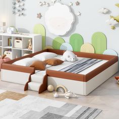 a child's bedroom with a bed, bookcases and toys on the floor