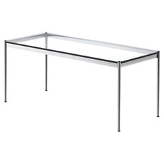 a glass table sitting on top of a white floor next to a black metal frame