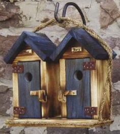 two wooden bird houses hanging on a rope