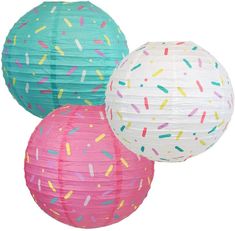 three paper lanterns with sprinkles on them