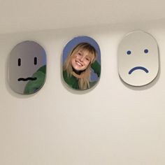 three mirrors with faces on them in the shape of smiley faces