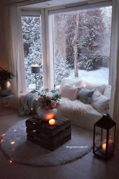 a living room filled with furniture next to a large window covered in frosted trees