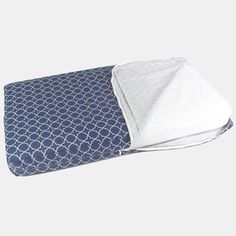 the blue and white blanket is folded on top of the pillow cover, which has an interlocked pattern