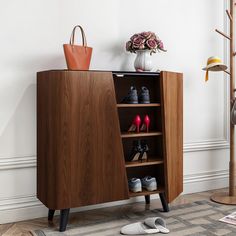 a wooden cabinet with shoes on it in a room