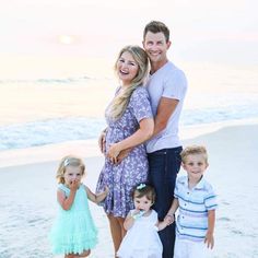 a family poses for a photo on the beach