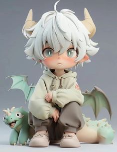 an anime figurine sitting next to a dragon