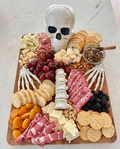 a skeleton is sitting on top of a platter of food