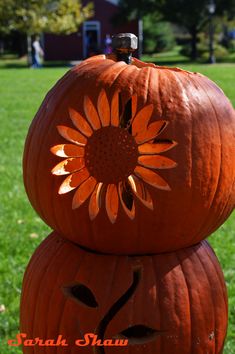 two pumpkins are stacked on top of each other