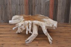 a piece of driftwood sitting on top of a wooden floor