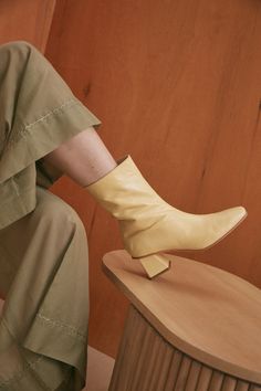 The Ola Glove Boot is a block-heeled boot featuring a tapered square toe, contoured shaft and pyramidal heel. The extended shaft hits right at the low calve making this silhouette ideal for styling with mid-to-maxi length hems to avoid unwanted skin exposure. Lacking the bulk of a full shaft riding boot, this style can also be worn to anchor denim and trousers with a modern and distinctive toe shape. At barely 2 inches, the block offers a realistic height for a full day of wear. The Ola Glove bo Elegant Mid-calf Boots With Stacked Heel And Square Toe, White Mid-calf Boots With Stacked Heel And Pointed Toe, White Ankle-high Boots With Vibram Sole, Tapered Square, Riding Boot, The Low, Vegetable Tanned Leather, The Block, Tan Leather