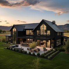 this is an aerial view of a modern house in the mountains at sunset or dawn