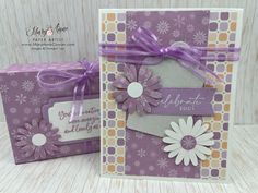 two greeting cards with purple ribbons and flowers on them, one has a tag that says celebrate you