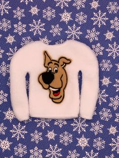 a white sweater with a dog on the front and snowflakes in the back