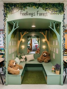 two teddy bears are sitting on the bench in front of a tree - themed booth