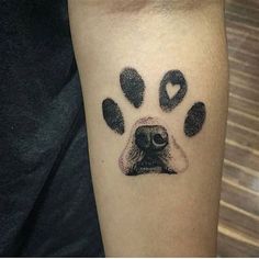 a dog's paw print with hearts on the left side of his right arm