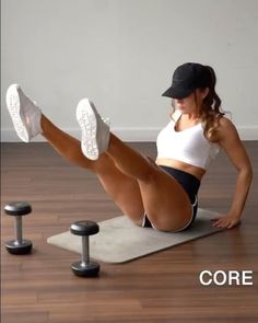 a woman is doing exercises on a mat