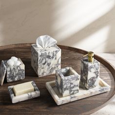 marble bathroom accessories on a wooden tray