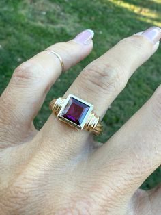 The lovely genuine garnet measures 7mm x 7mm.  Ring weighs 4.5g and measures 8.5mm at its widest point. It is stamped 14k yellow gold. The ring is a size 7.25 and sizable.  We are happy to provide sizing for an additional charge. Please ask if you need a quote. Yellow Gold Garnet Signet Ring With Gemstone, Classic Garnet Signet Ring For Anniversary, 14k Gold Ruby Ring In Art Deco Style, 14k Gold Art Deco Ruby Ring Gift, Emerald Cut Hallmarked Ruby Ring In 14k Gold, Gold Garnet Signet Ring For Anniversary, Gold Amethyst Ring With Emerald Cut, Birthstone, Gold Emerald Cut Amethyst Birthstone Ring, 14k Gold Emerald-cut Amethyst Ring